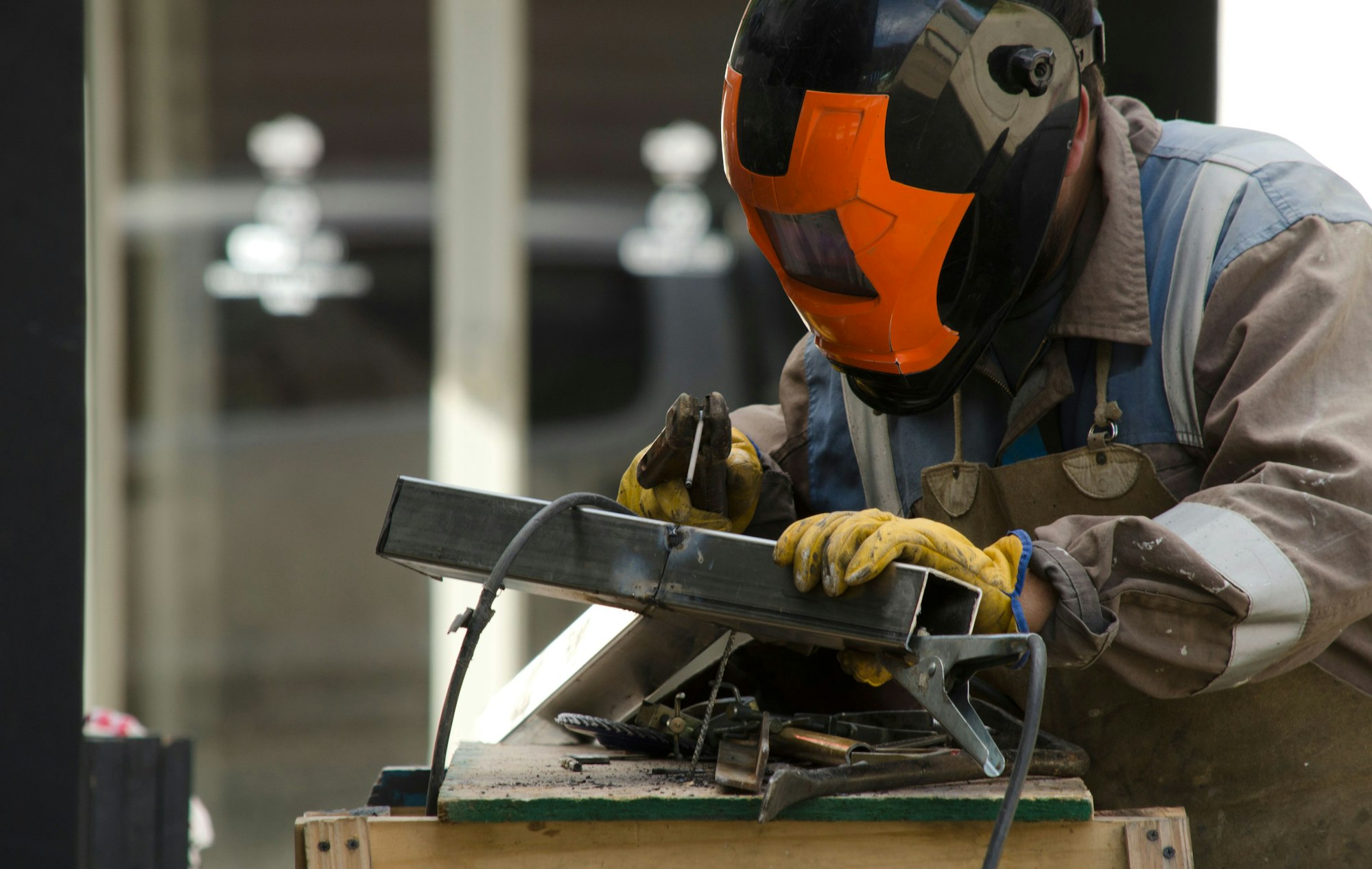 Blacksmith engaged in the process of metalworking, using tools to shape a metal object